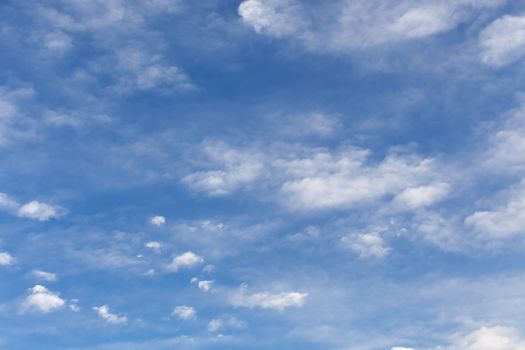 The beautiful blue sky with white clouds in the light of a rising sun