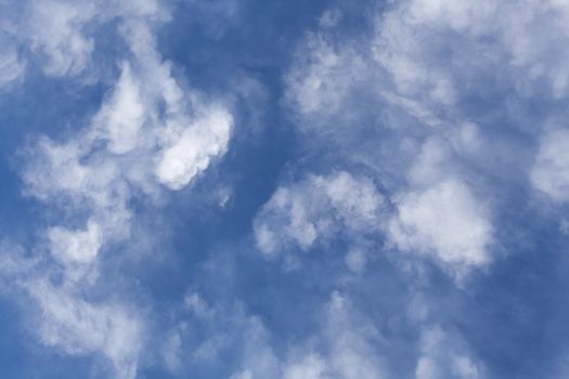 The beautiful blue sky with white clouds in the light of a rising sun