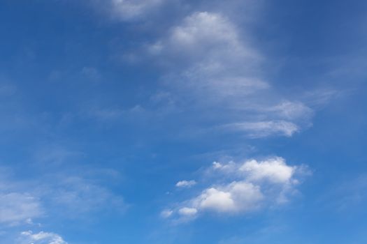 The beautiful blue sky with white clouds in the light of a rising sun