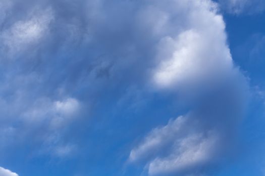 The beautiful blue sky with white clouds in the light of a rising sun