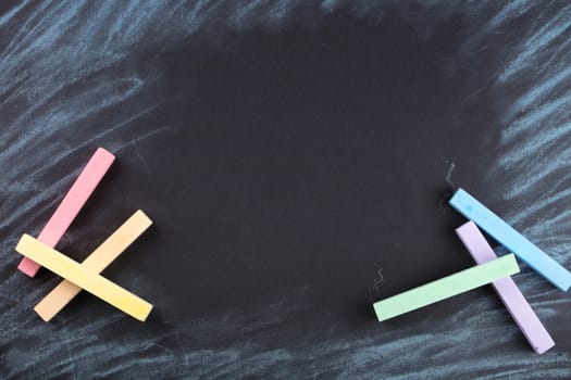 colorful crayons are painted on a black background
