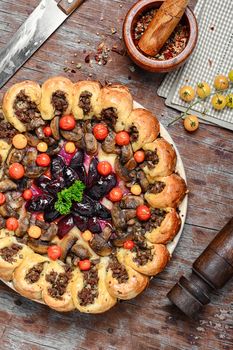 Traditional pie stuffed with meat decorated vegetables