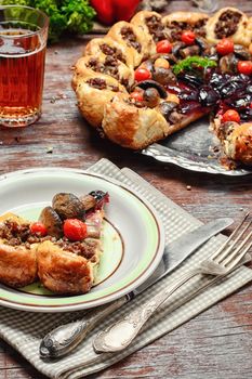 Traditional pie stuffed with meat decorated vegetables