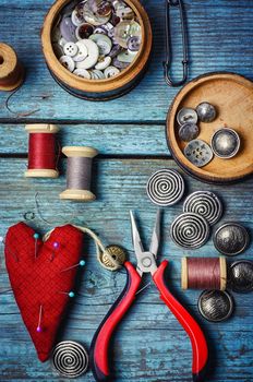 Beads and pliers to assemble the necklace on blue background