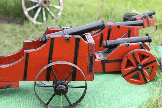 Miniature antique vintage artillery gun with wooden base and metal barrel