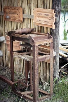 Antique machine for the production of tiles with product samples on the wall