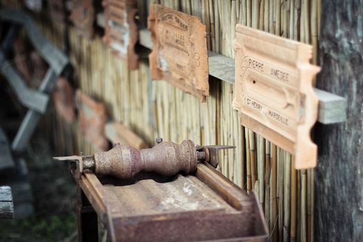 Antique machine for the production of tiles with product samples on the wall