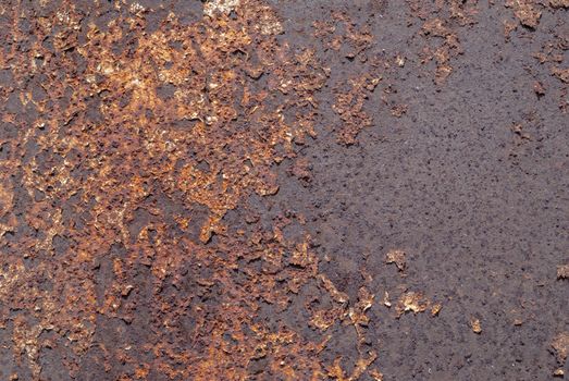 rusty iron surface covered with old chipped paint, which has long been influenced by different climatic conditions