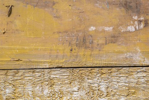 texture of wooden surface with remnants of old paint that has dried and cracked under the influence of weather