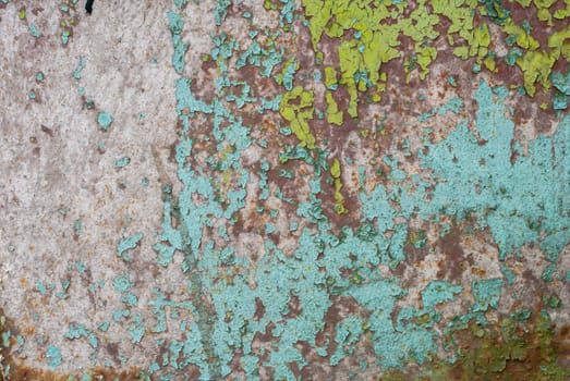 fragment of an iron surface is covered with green and blue color paint, which has long been under the influence of different climatic conditions