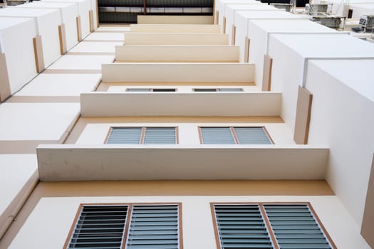 Look up at apartment housing in Thailand. Step of building.