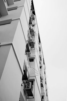 Look up at apartment housing in Thailand. Step of building.