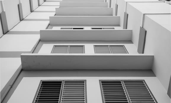 Look up at apartment housing in Thailand. Step of building.