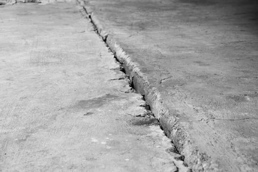 Crack in the concrete floor. Step in the walk