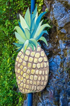 A big pineapple on a post outdoors