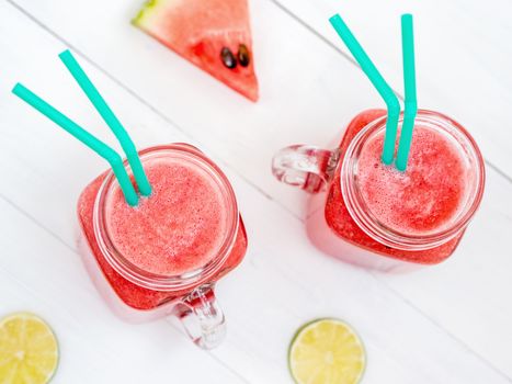 Watermelon smothie and slices on white wooden background. Top view