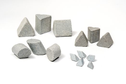 Industrial  sharpening stones sets in different shapes on white background