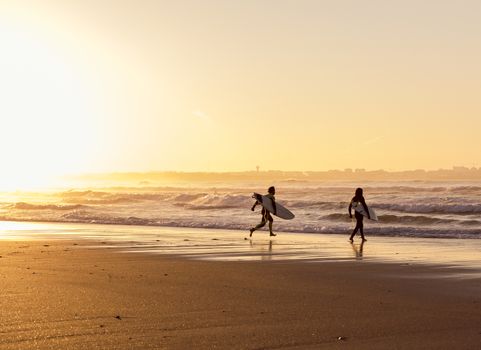 Beautiful beach lansdscape with surfers ready to hit the waves