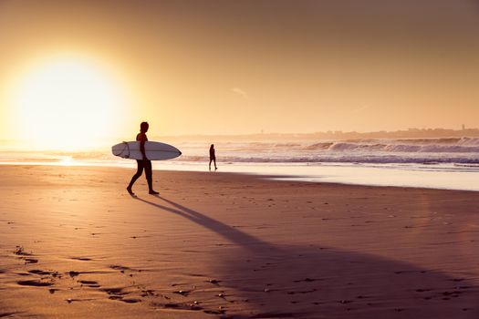 Beautiful beach lansdscape with surfers ready to hit the waves