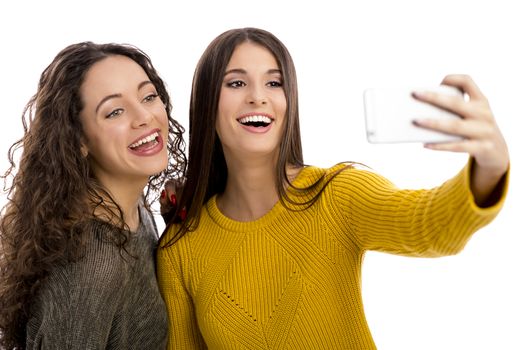 Teen girls with smartphone taking selfie
