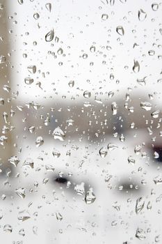 On a winter raining day. Drops of water on the window. Shallow DOF