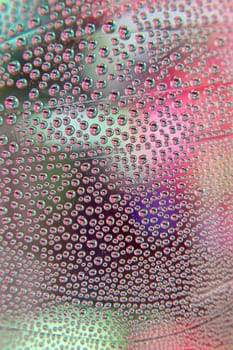 Abstract background. Drops of water on the crooked glass, shallow dof