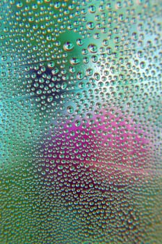 Abstract background. Drops of water on the crooked glass, shallow dof