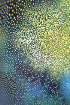 Abstract background. Drops of water on the crooked glass, shallow dof