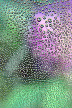 Abstract background. Drops of water on the crooked glass, shallow dof