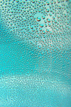 Abstract background. Drops of water on the crooked glass, shallow dof