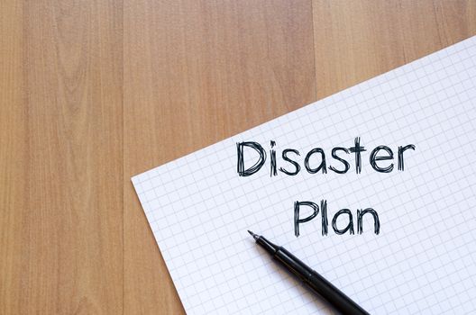 Disaster plan text concept write on notebook with pen