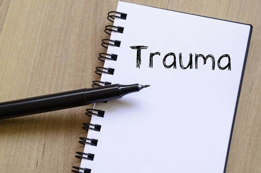 Trauma text concept write on notebook with pen