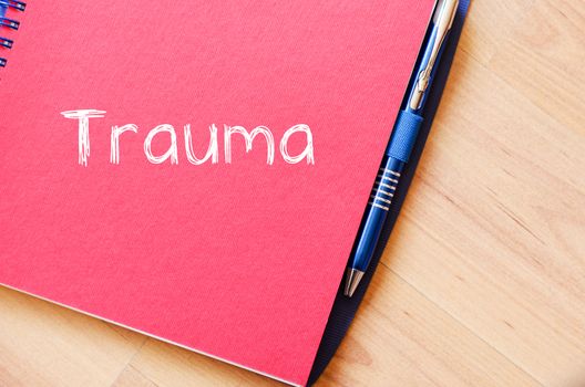 Trauma text concept write on notebook with pen