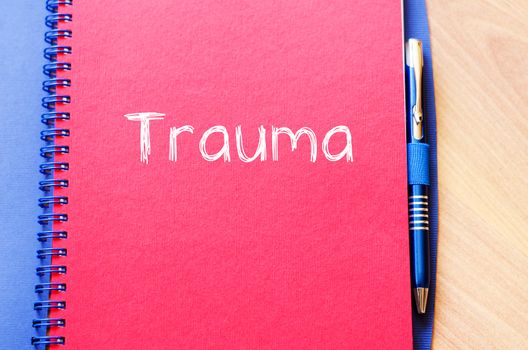Trauma text concept write on notebook with pen