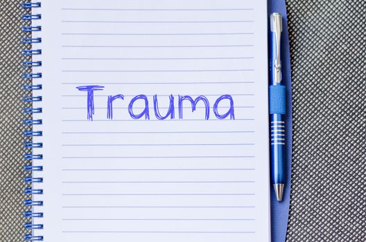 Trauma text concept write on notebook with pen