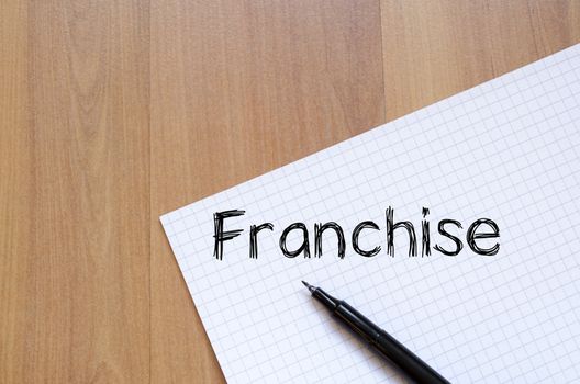 Franchise text concept write on notebook with pen