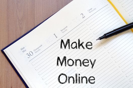 Make money online text concept write on notebook with pen