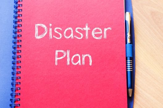 Disaster plan text concept write on notebook with pen