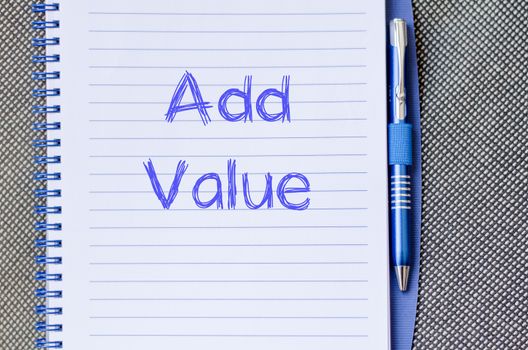 Add valuer text concept write on notebook with pen