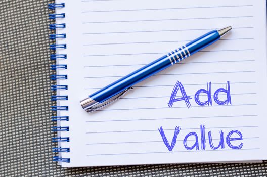 Add valuer text concept write on notebook with pen