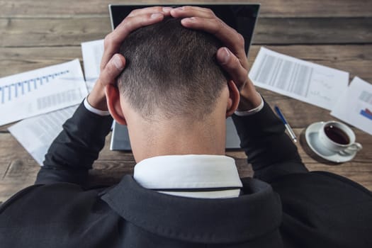 Businessman working in the office and feel headache