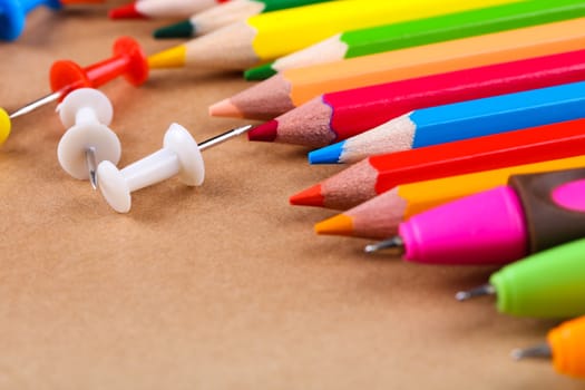 set of colored pencils and buttons closeup