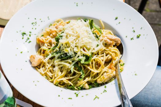 Spaghetti bolognese. Plate of Italian spaghetti, spinach, chicken and Parmesan cheese.