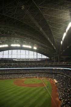 Milwaukee Brewers fans await a baseball game against the Chicago Cubs under a closed dome.