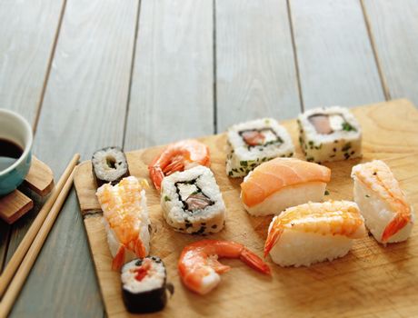 Selection of sushi seafood with rice on top of a wooden table background with space 