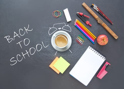 Back to school background with alarm clock drawn around a coffee cup and stationery accessories