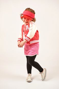 Little girl with red cap standing and smiling