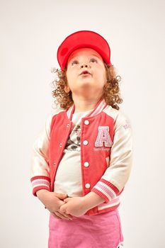 Little girl with red cap standing and smiling