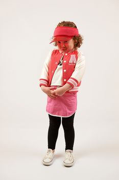 Little girl with red cap standing and smiling