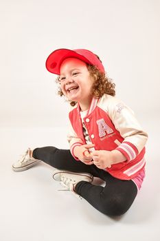 Little girl with red cap standing and smiling